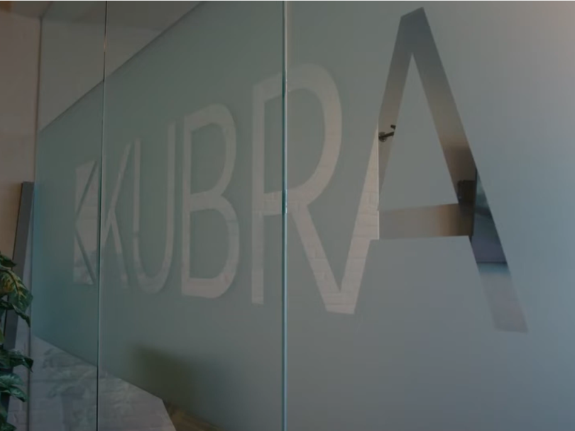 An image of KUBRA’S logo engraved on a glass wall in the company’s office